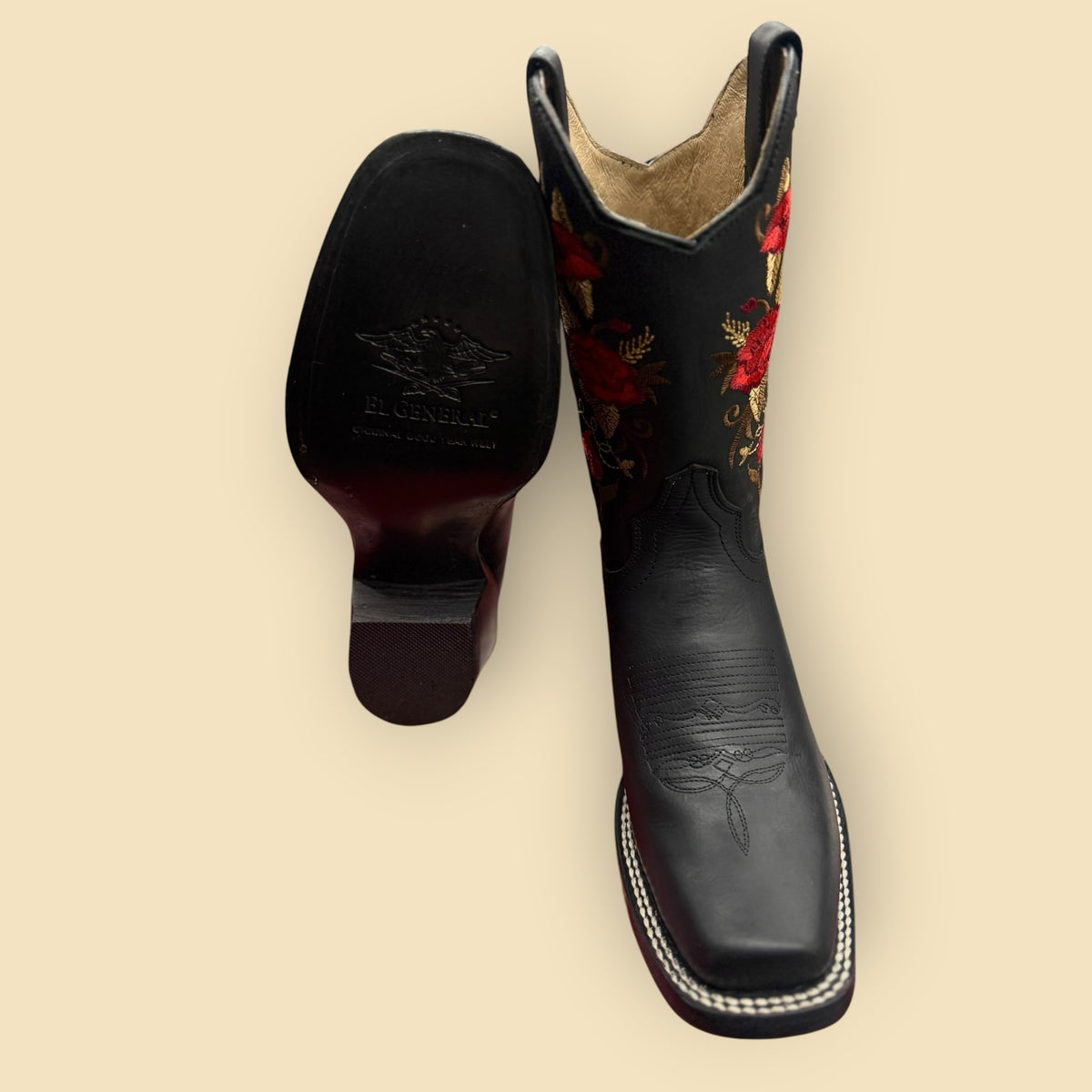 Lopez Fashion black leather cowboy boots with red floral embroidery and square toe, showing sole and front view.
