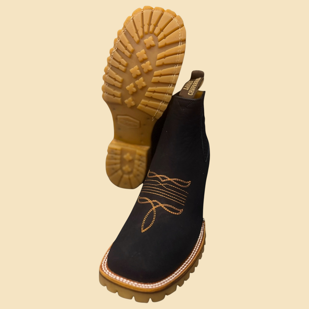 Lopez Fashion black suede Chelsea boots with western embroidery and a tan Vibram lug sole, shown from above.