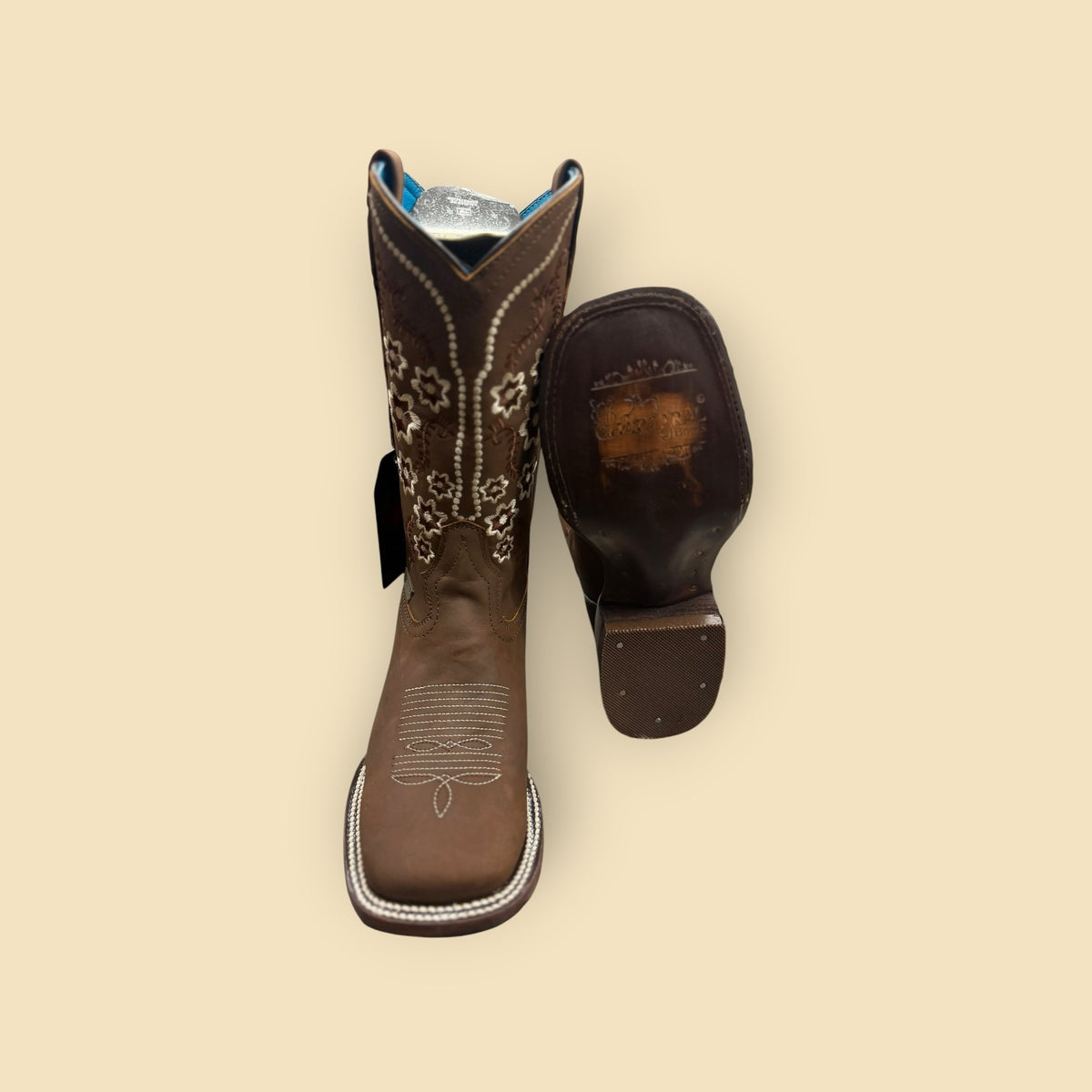 Lopez Fashion brown leather Western boots with white floral embroidery and square toe, featuring a vibrant blue lining.