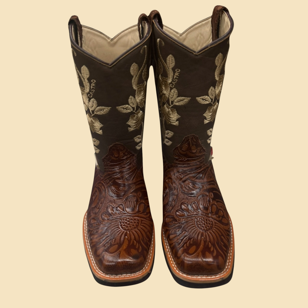 Lopez Fashion Castro brown leather cowboy boots with intricate floral embossing and golden embroidery on a square toe.