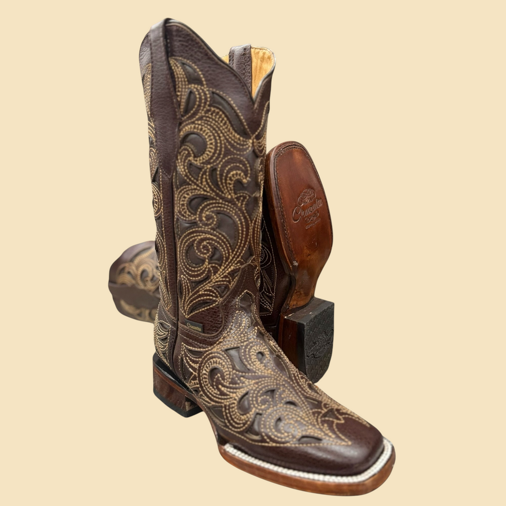Lopez Fashion Cruzalca brown leather cowboy boots with intricate light-toned embroidery and a classic square toe.