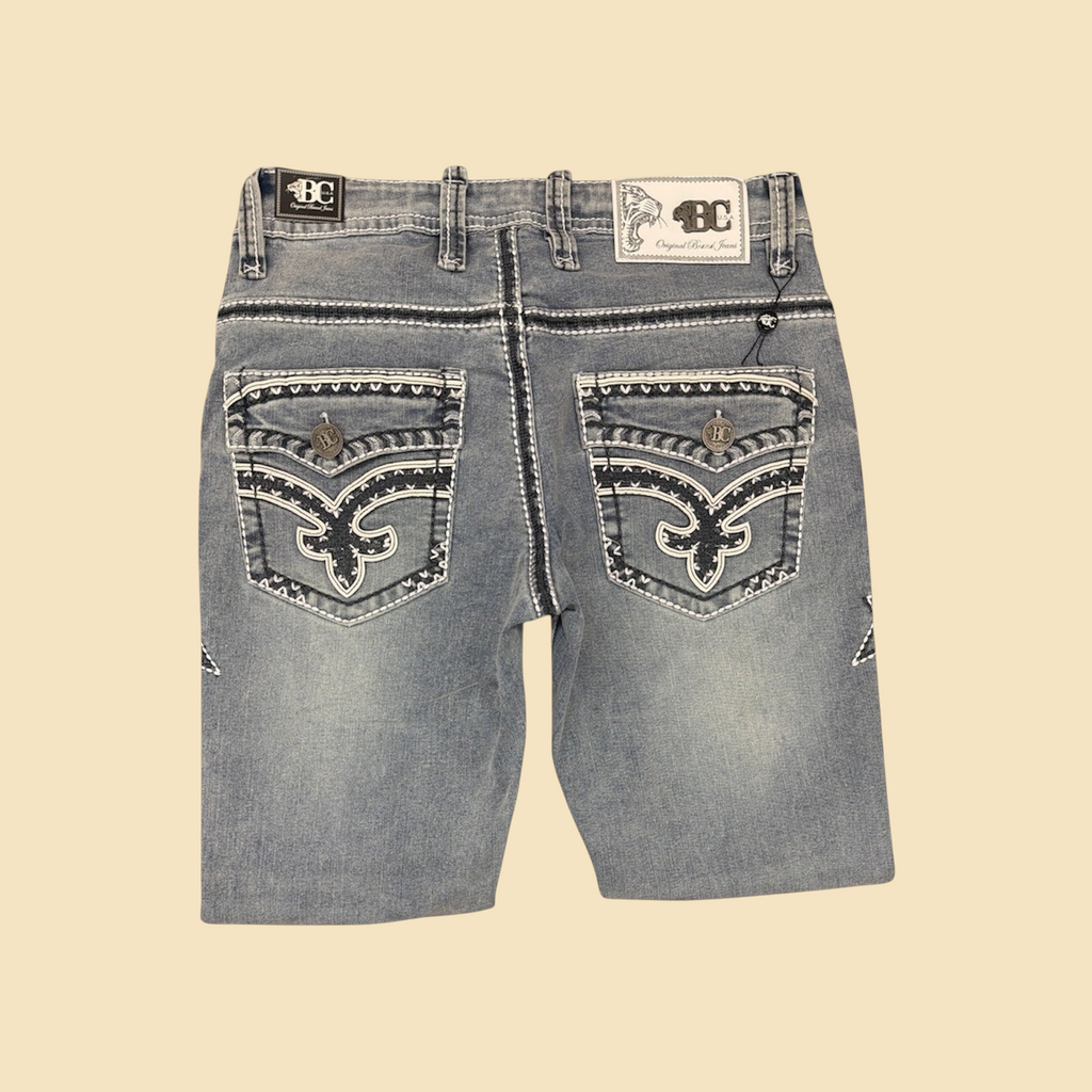Lopez Fashion light-wash denim jeans with intricate white embroidery, contrast stitching, and branded button pockets.