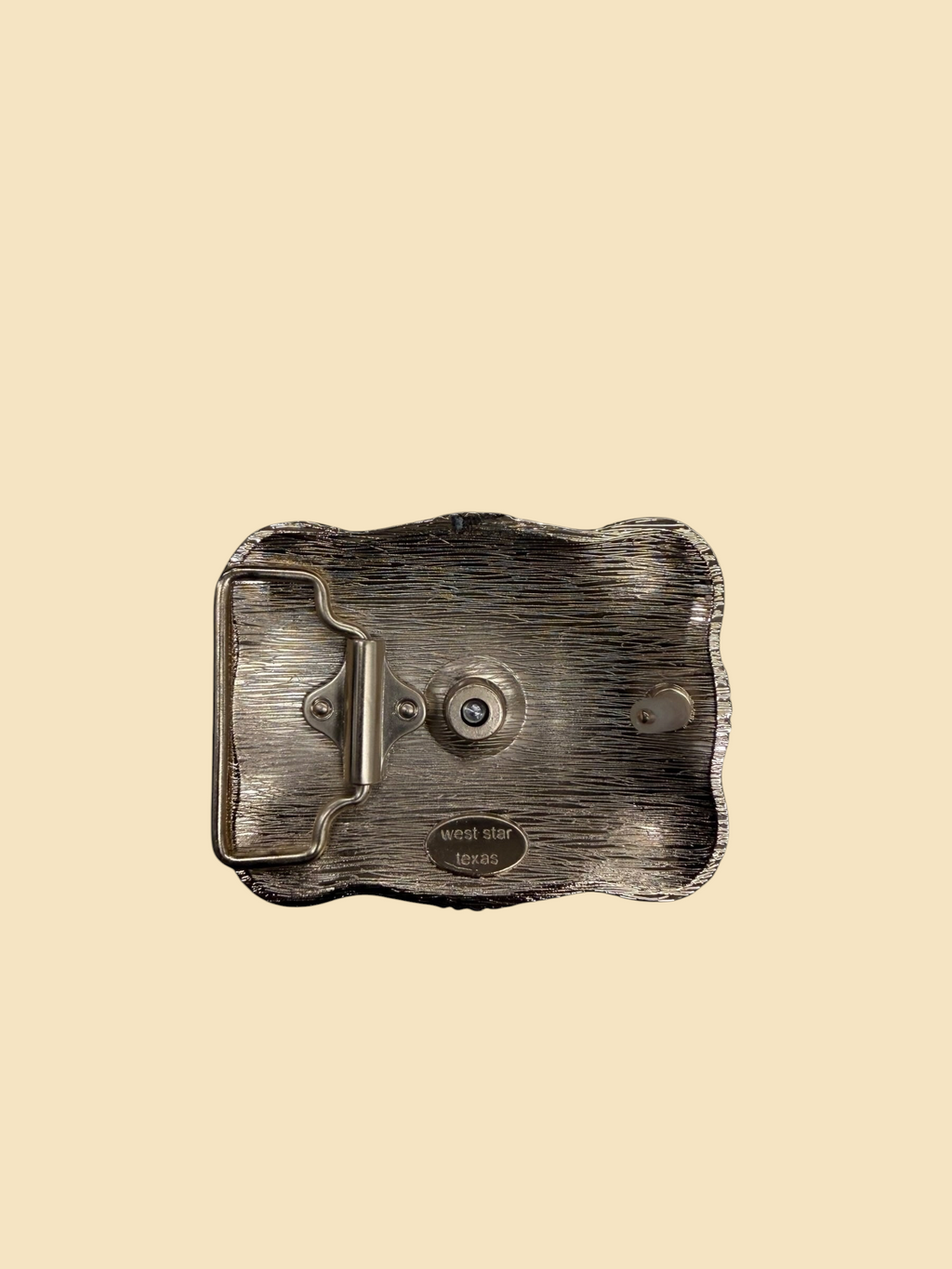 Back view of a Lopez Fashion silver-tone western belt buckle featuring a textured finish and West Star Texas branding.